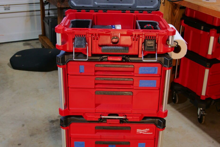 Milwaukee Packout system in a garage, organized with various tool compartments and stickers.