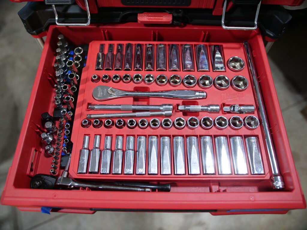 Close-up of a Milwaukee Packout drawer showcasing a well-organized socket and ratchet set.